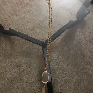 Long gold plated necklace with jewel.